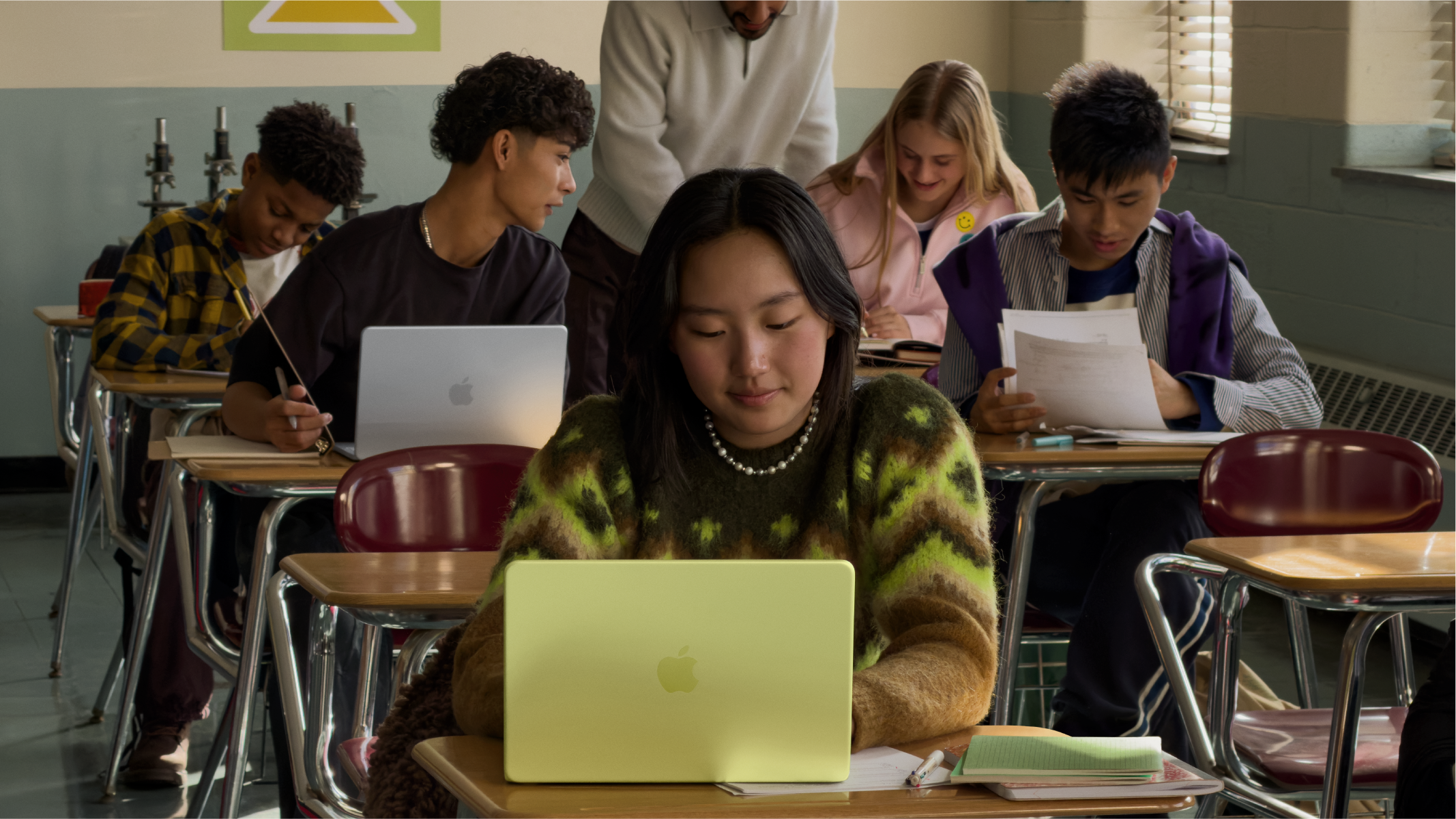 Students learning with Apple devices in a classroom